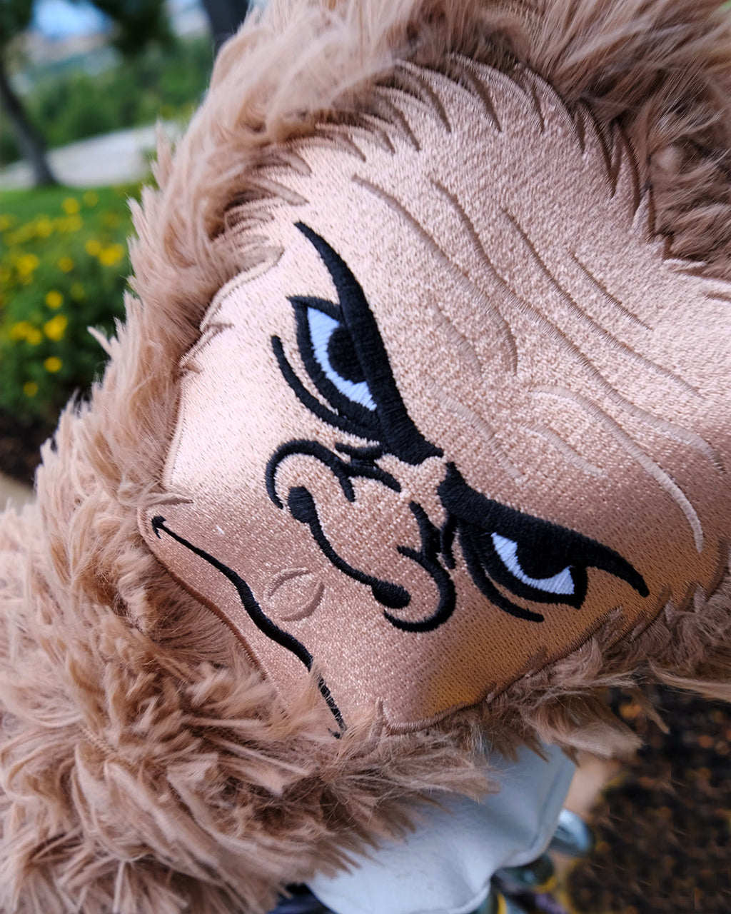 close up of Bigfoot sasquatch golf driver cover with blurred background