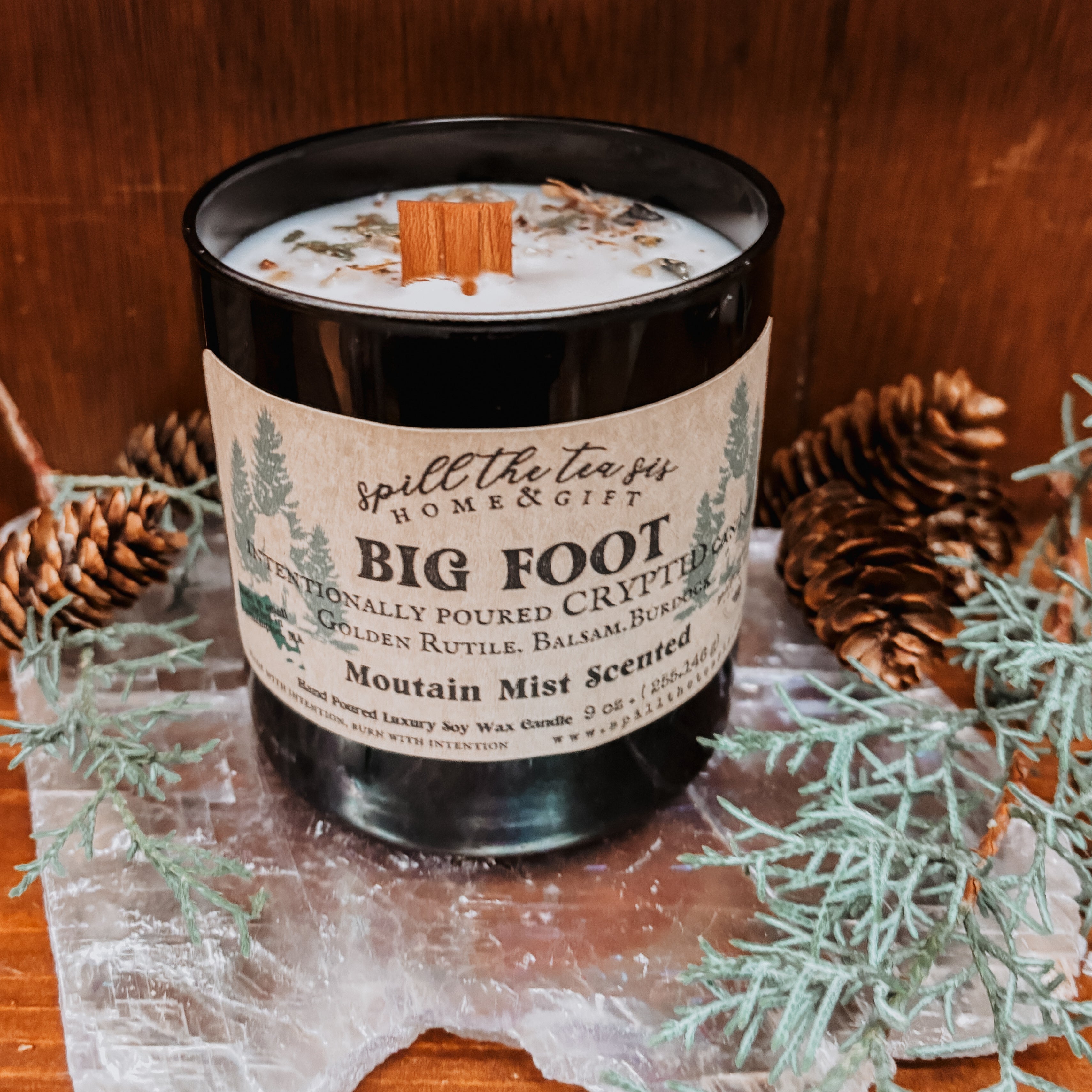 Candle with a label on a wooden surface with decorative elements