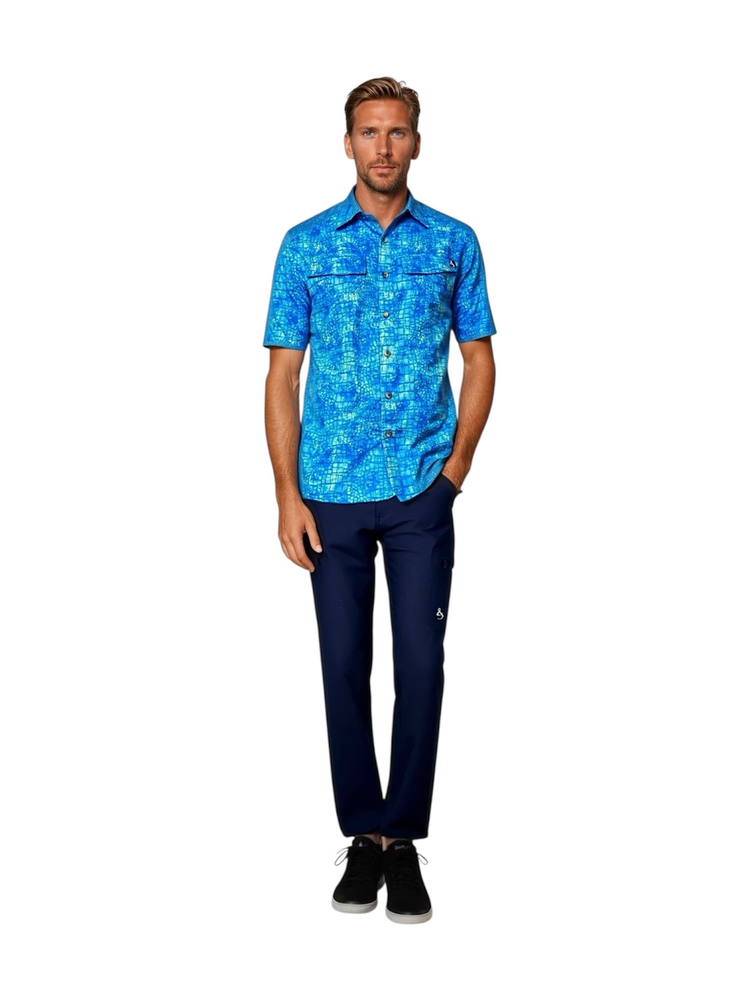Man wearing a blue patterned shirt and dark pants on a white background