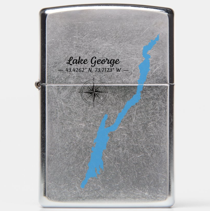 A silver metal lighter with a distressed finish, featuring a blue map graphic of Lake George with the text 'Lake George' and coordinates printed on the front.